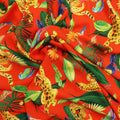 Orange Background with Multicolored Leaves and Animals Printed Fabric - Rex Fabrics